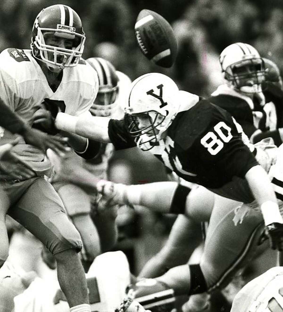 Harvard's Tim Perry in the middle of a pitch to Silas Myers during The Game at the Yale Bowl, November 18, 1989.