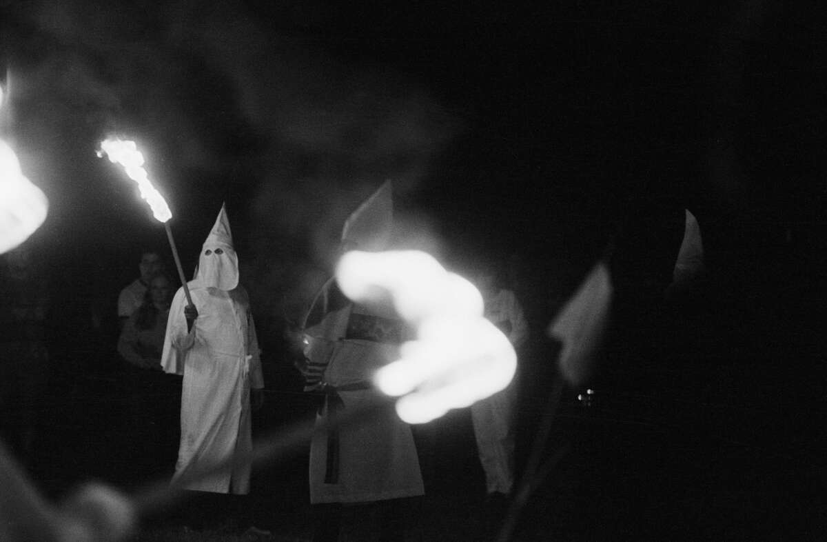 A group of Ku Klux Klansmen start burning a cross in East Windsor, Connecticut.