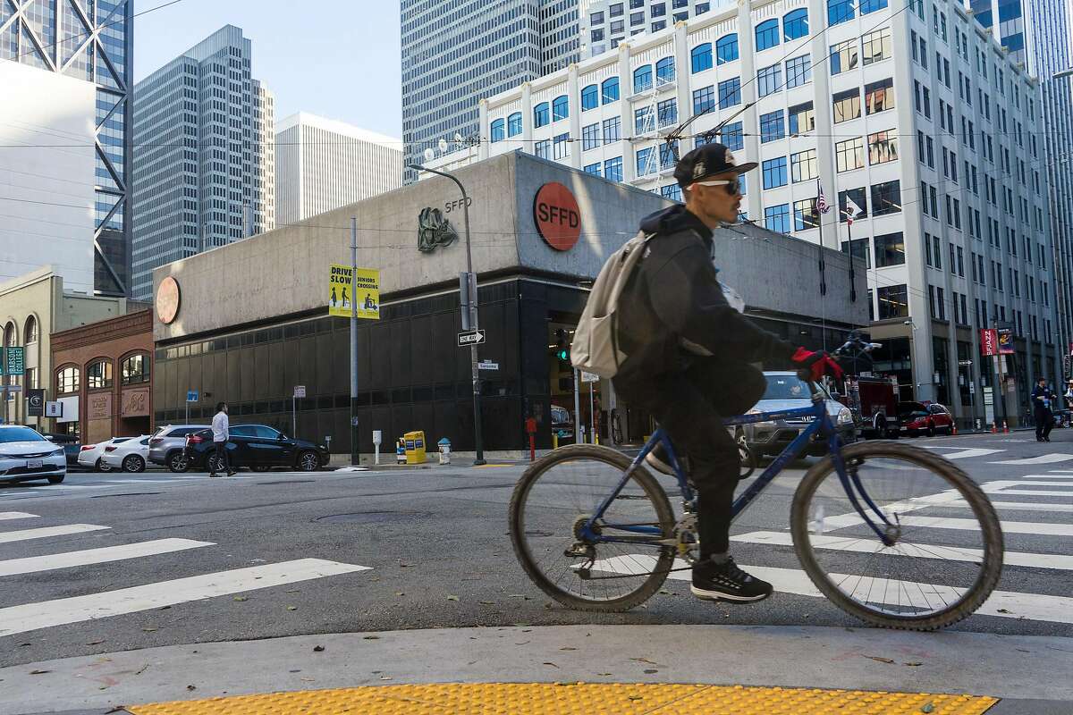 A cyclist passes the fire station at 530 Sansome St. in San Francisco, Calif. on Monday, Jan. 21, 2018. The city is proposing building a fire station and housing at 530 Sansome Street and then use that money from that sale to build affordable housing at 772 Pacific Avenue.