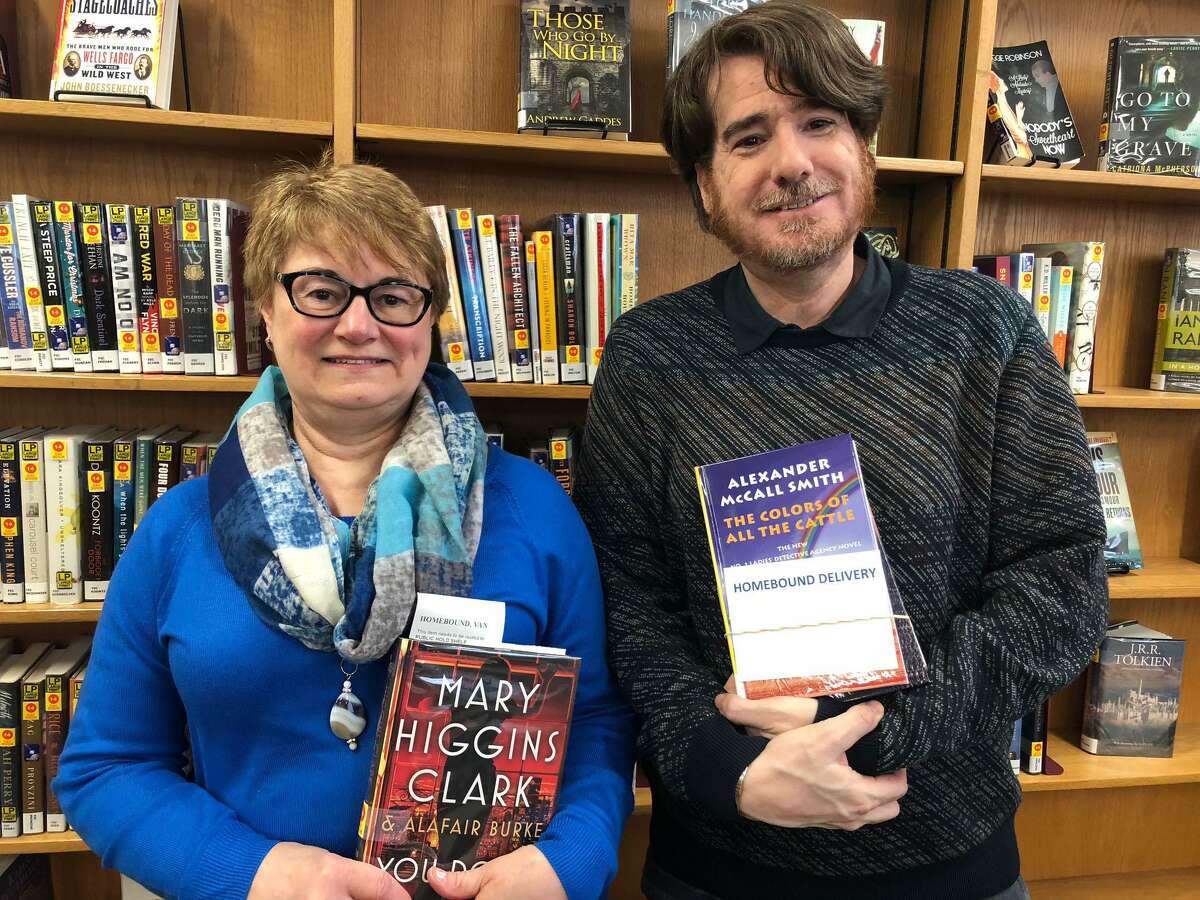 Huntington Library Branch Director Marcia Austin and Circulation Supervisor Scott Brill with books that will be delivered to Shelton residents