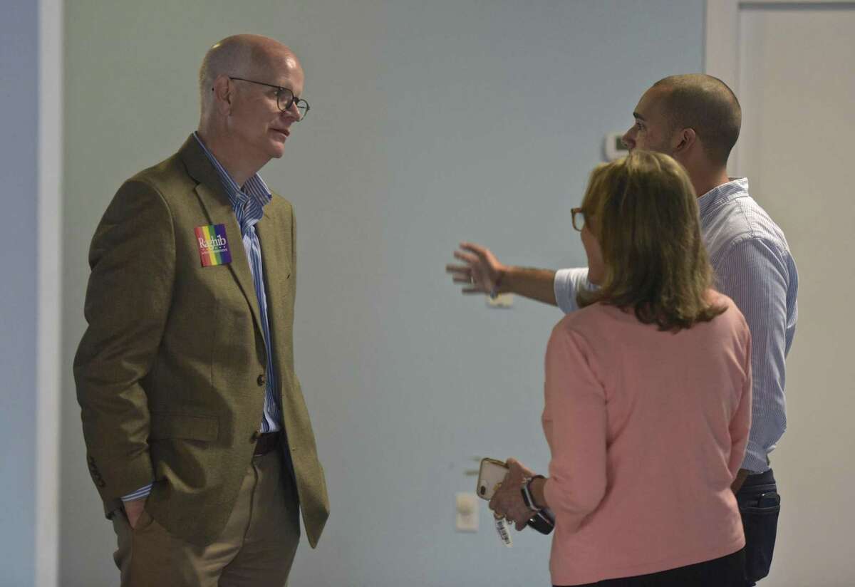 State Comptroller Kevin Lembo, left, talks with Raghib Allie-Brennan, a Democrat running for the state House in the 2nd District., and Julie Kushner, running for State Senate in the 24th district, during an LGBTQ day of action. Saturday, October 6, 2018, Bethel, Conn.