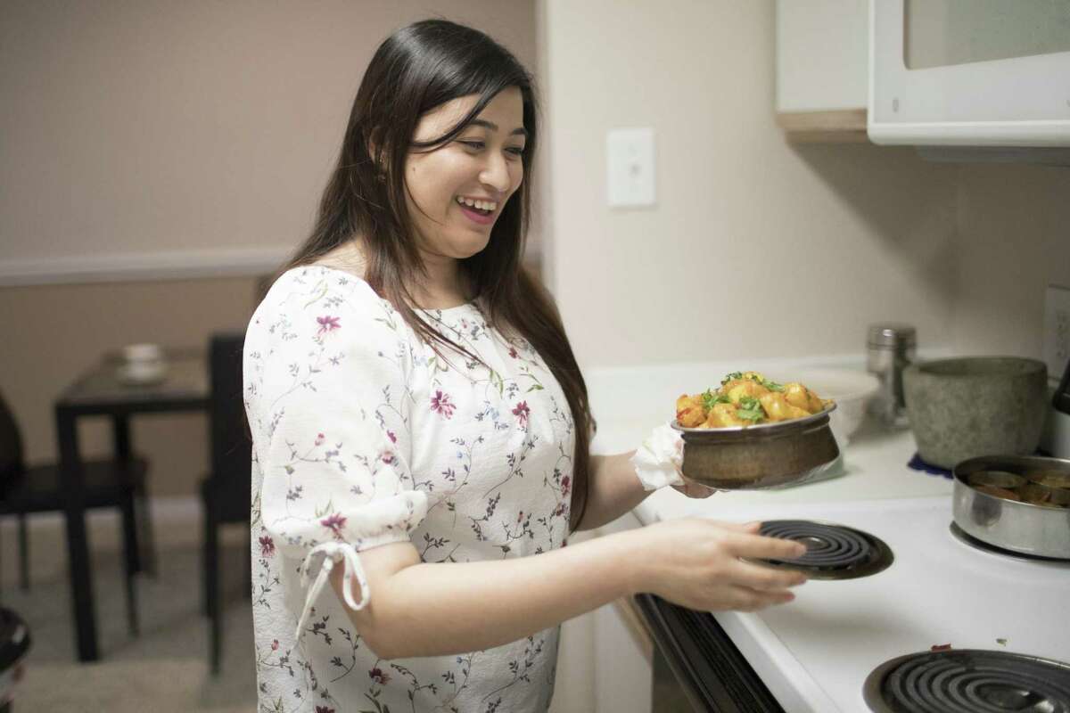 Rachana Shakya, 30, prepares spiced potatoes after work on Tuesday, Jan. 15, 2019, northwest of Houston. Shakya is original from Nepal and moved to Houston to join her husband four years ago.