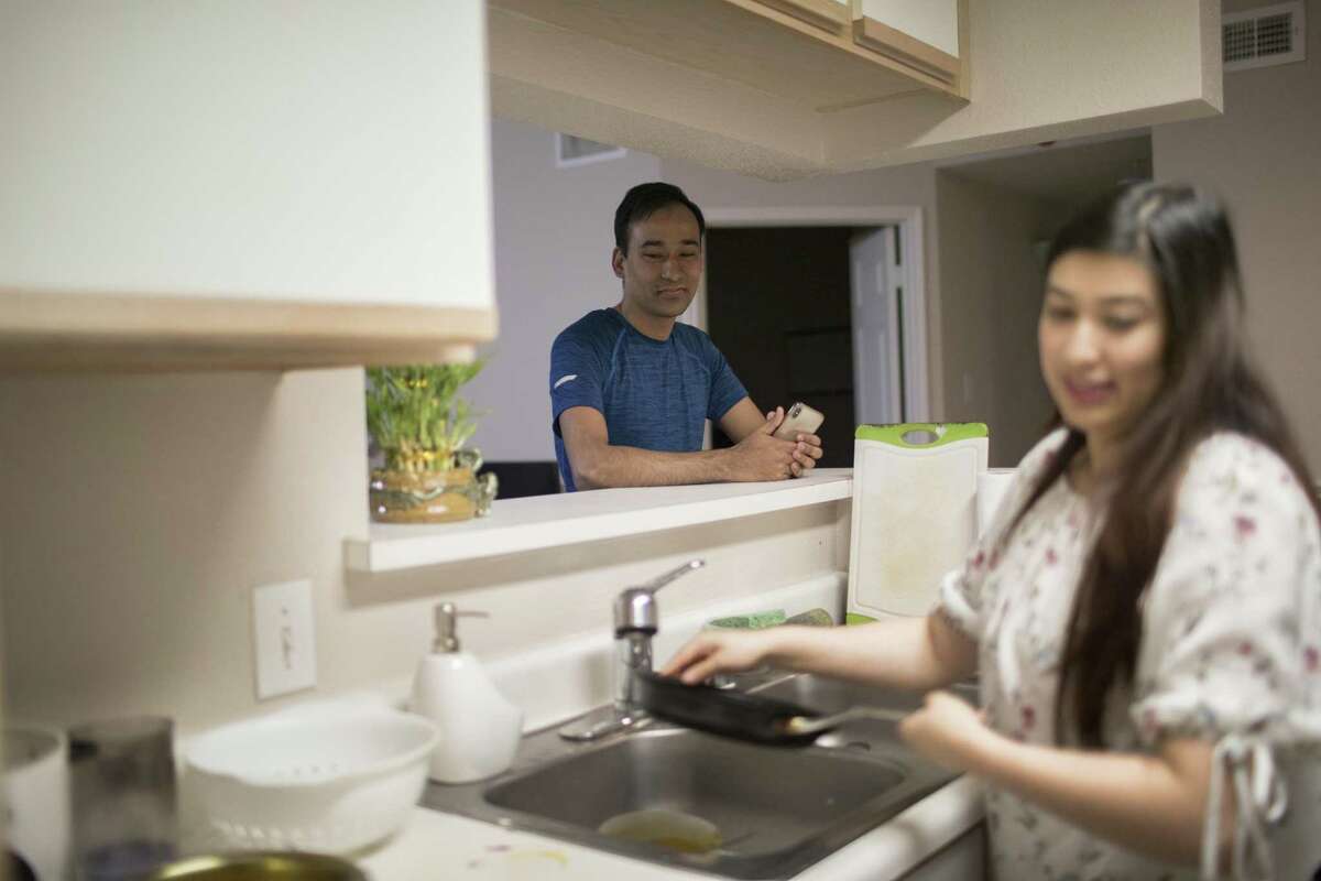 Ram Chakradhar, 34, observes as his wife Rachana Shakya, 30, finishes preparing Newari appetizers at their home in Houston on Tuesday, Jan. 15, 2019. Chakradhar prepares videos of his wife's cooking and upload them to YouTube.