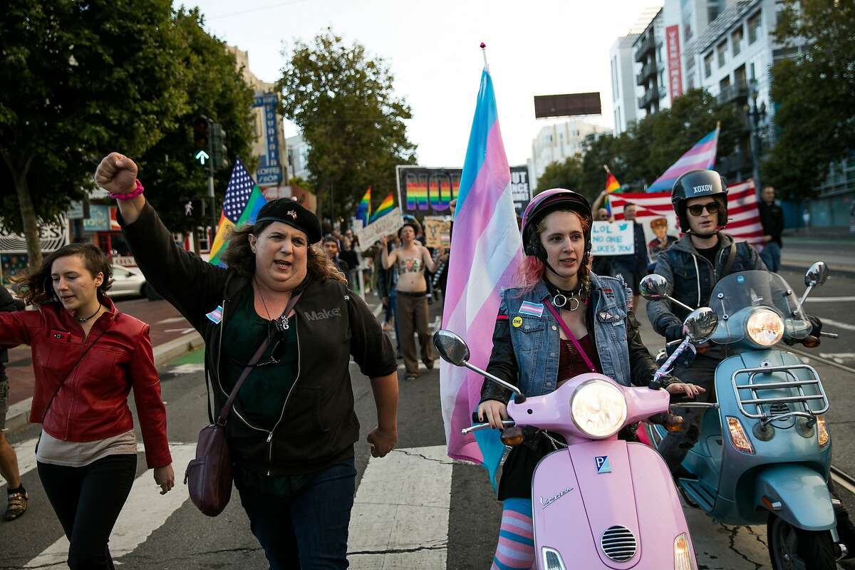 Hundreds of people begin their march down Market Street to protest against President Trump's tweeted vow to ban transgender people from the military on Wednesday, July 26, 2017, in San Francisco, Calif.