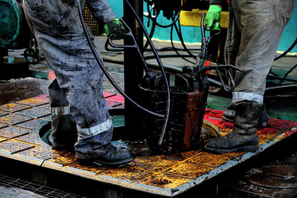 Floor hands work Monday June 27, 2016 at Abraxas Petroleum's Bullseye 101H well being drilled in the Austin Chalk formation in Atascosa County near Jourdanton, Texas. The Austin Chalk formation lies atop the Eagle Ford.