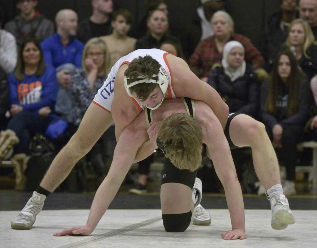 Trumbull’s William Holmes, in black, and Danbury’s Ben Leblanc, in white, wrestle in the 145-pound weight class during a Jan. 16 match.