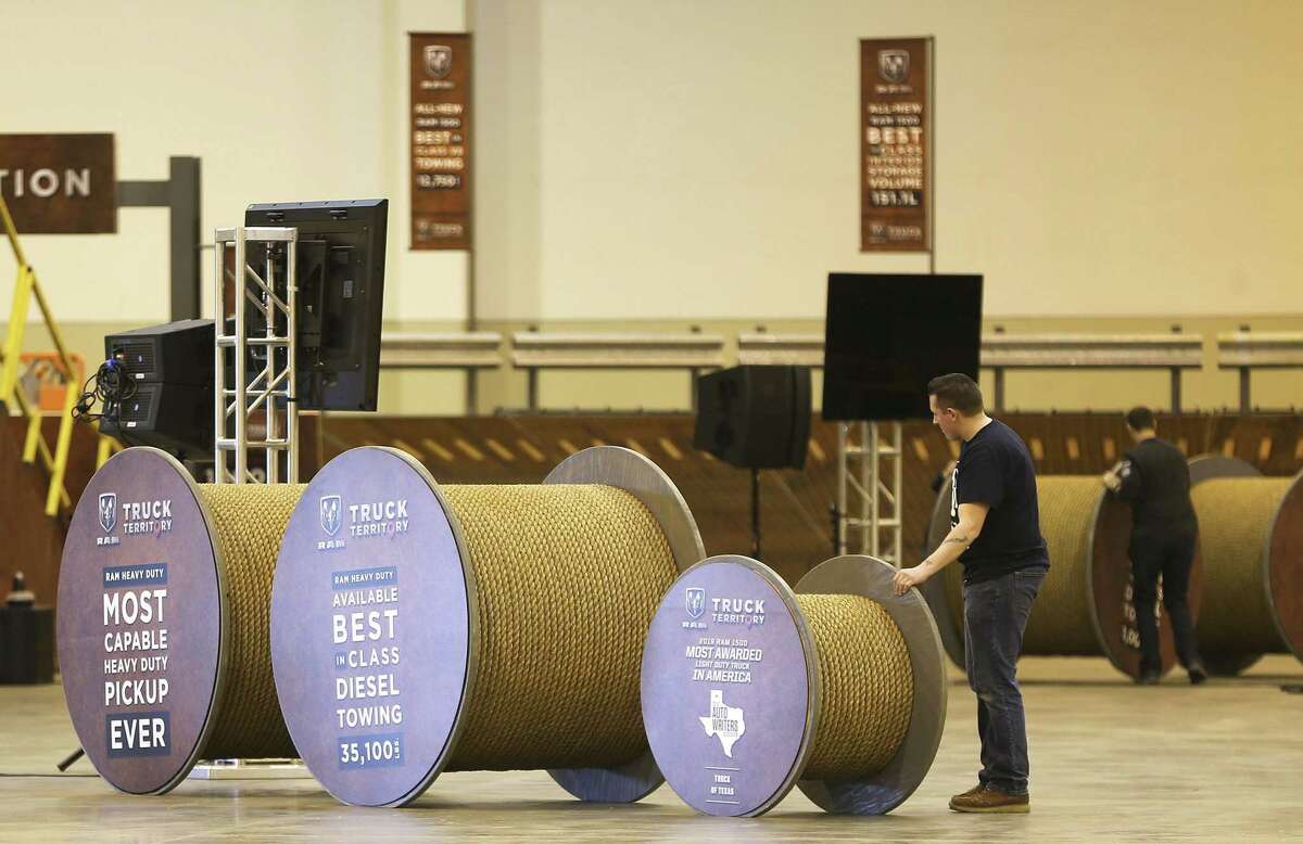 Workers display spools the Jeep Display for the Houston Auto Show at NRG Center on Tuesday, January 22, 2019.