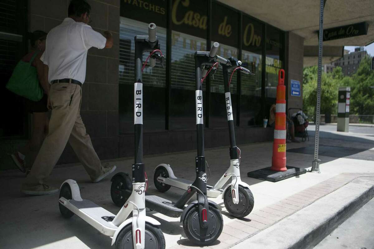Electric Bird scooters sit along Soledad Street in downtown San Antonio July 1, 2018. There are around 150 Bird electric scooters deployed downtown, in Dignowitty Hill, Government Hill and Southtown. Anyone can use them by downloading an app and paying $1 plus 15 cents per minute.