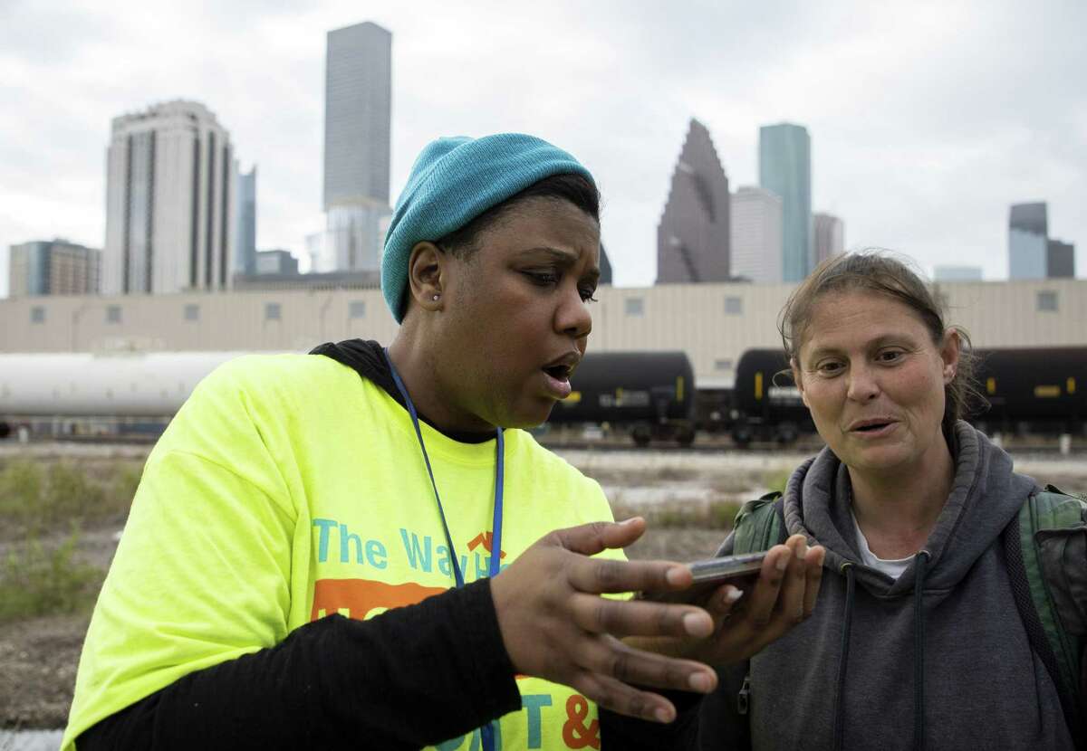 Tiffany Brown, left, conducts a questionnaire with Jimmie Jones during the Annual Houston Homeless Count Tuesday, Jan. 22, 2019, in Houston.
