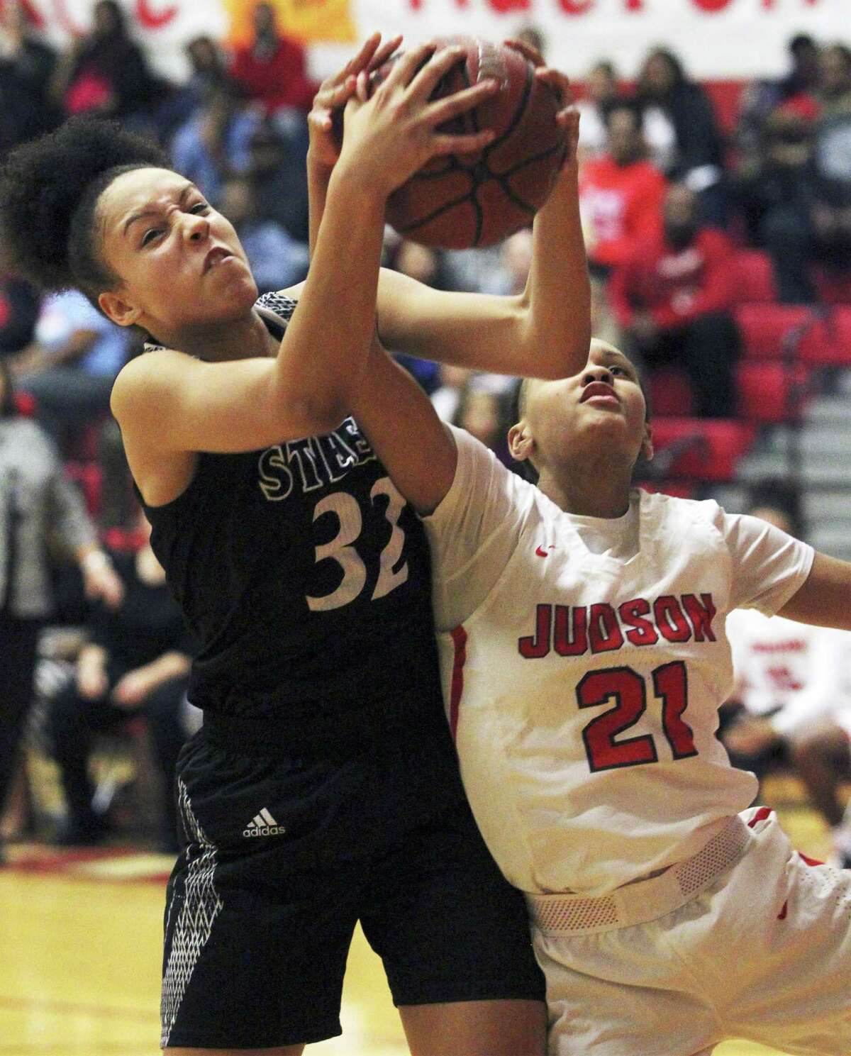 Steele's Sydney Cajero grabs a rebound over Tiffany McGarity as Judson hosts Steele in girls basketball at Judson High School gym on January 22, 2019.