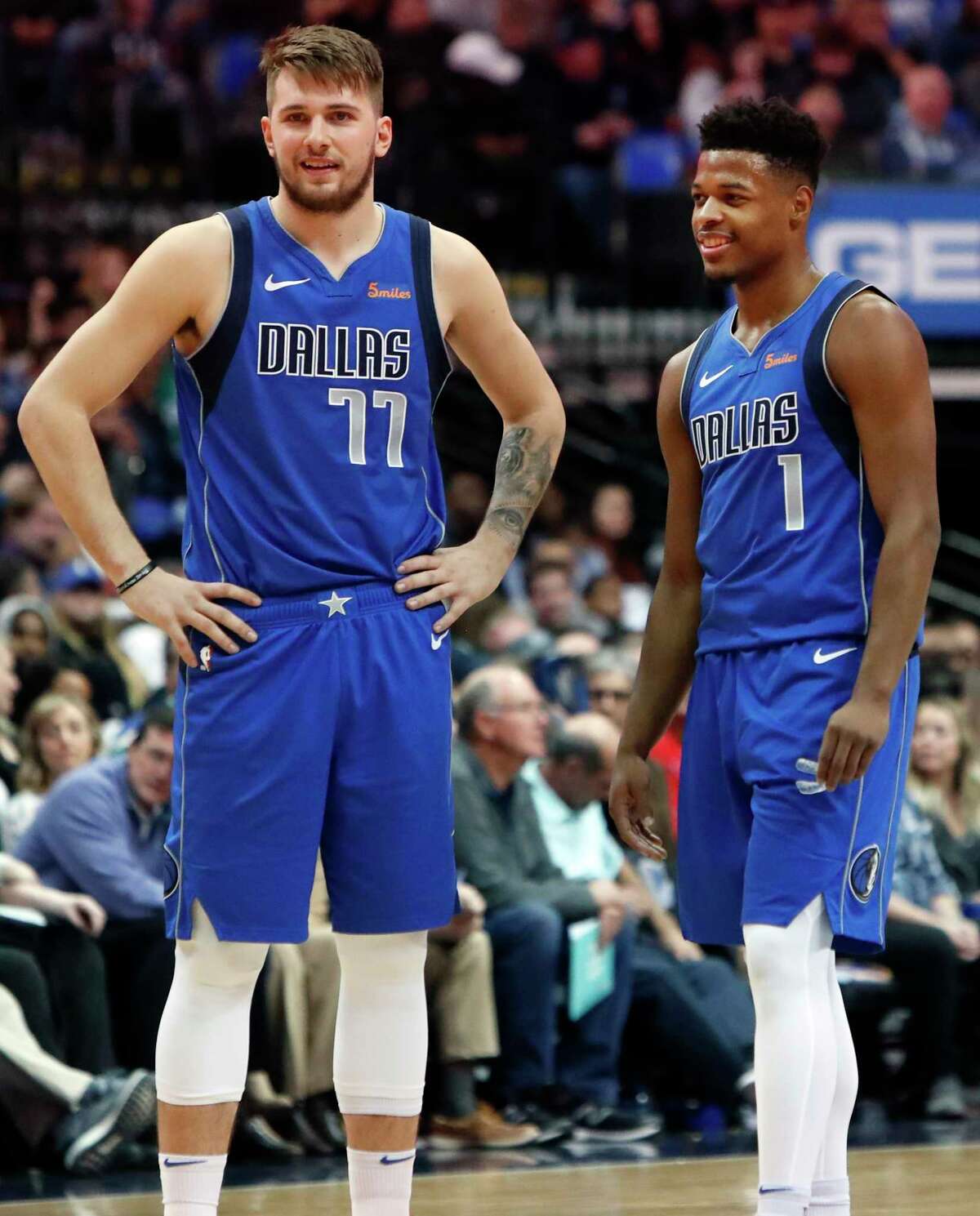 Dallas Mavericks Luka Doncic (77) of Germany and teammate Dennis Smith Jr. (1) share a laugh during the first half of an NBA basketball game against the LA Clippers in Dallas, Tuesday, Jan. 22, 2019. (AP Photo/LM Otero)