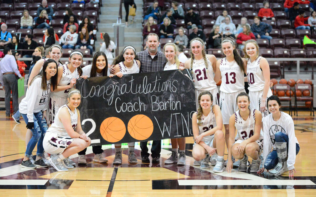 Abernathy Lady Anteopes head coach Justin Barton (center) is pictured with his team after reaching 200 career wins against Slaton on Tuesday night in Abernathy. Anaya Rodriguez (third from left) made the buzzer-beating shot to get the 40-38 win over the Tigerettes.