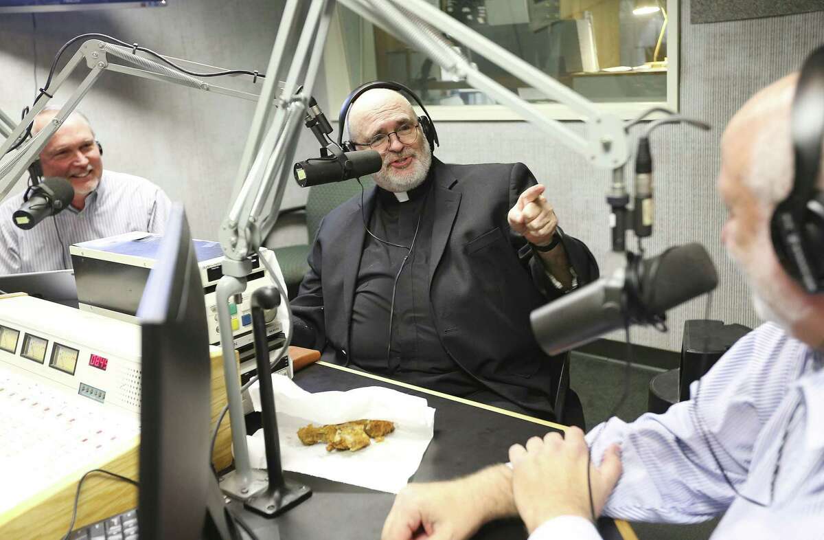 Father Mario Arroyo makes a point with Rabbi Stuart Federow, as Dr. David Capes smiles during the taping of "A Show of Faith", a local call-in radio station that discuss religion and news of the day on Sunday, Dec. 23, 2018 in Houston.