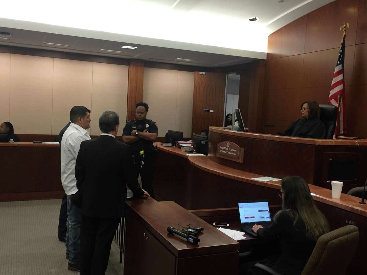 Israel Suerez Lugo, in white, in court Wednesday January 23. Prosecturos asked that the 34-year-old be held in lieu of $80,000 bail on a charge of intoxication assault. State District Judge Maria Jackson took Lugo into custody after hearing that a five-year-old may die because of a drunk driving wreck allegedly caused by Lugo.