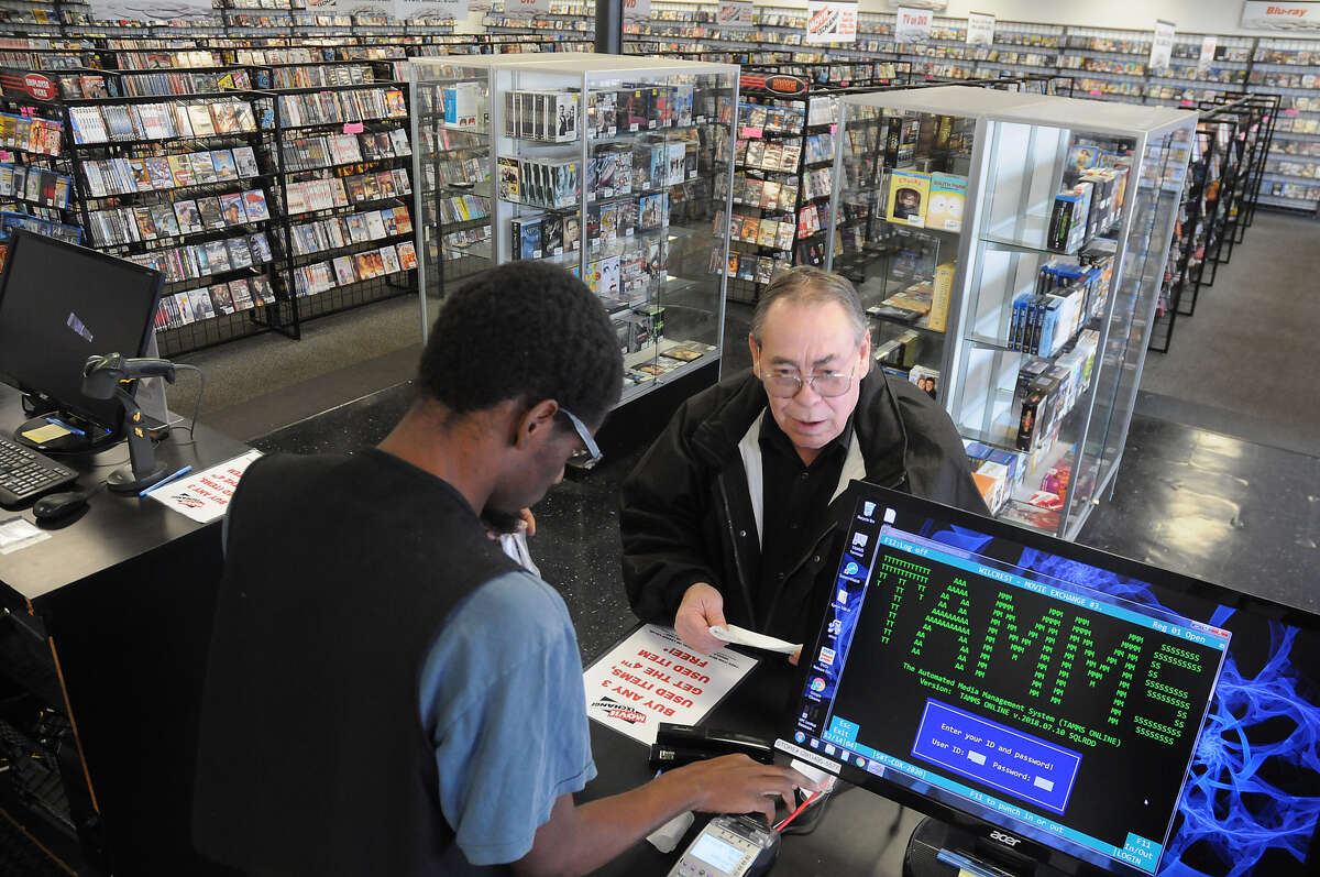 Regular customer Frank Logan buys a stack of DVD's from Xavier Readeaux at Movie Exchange at 11803 Wilcrest