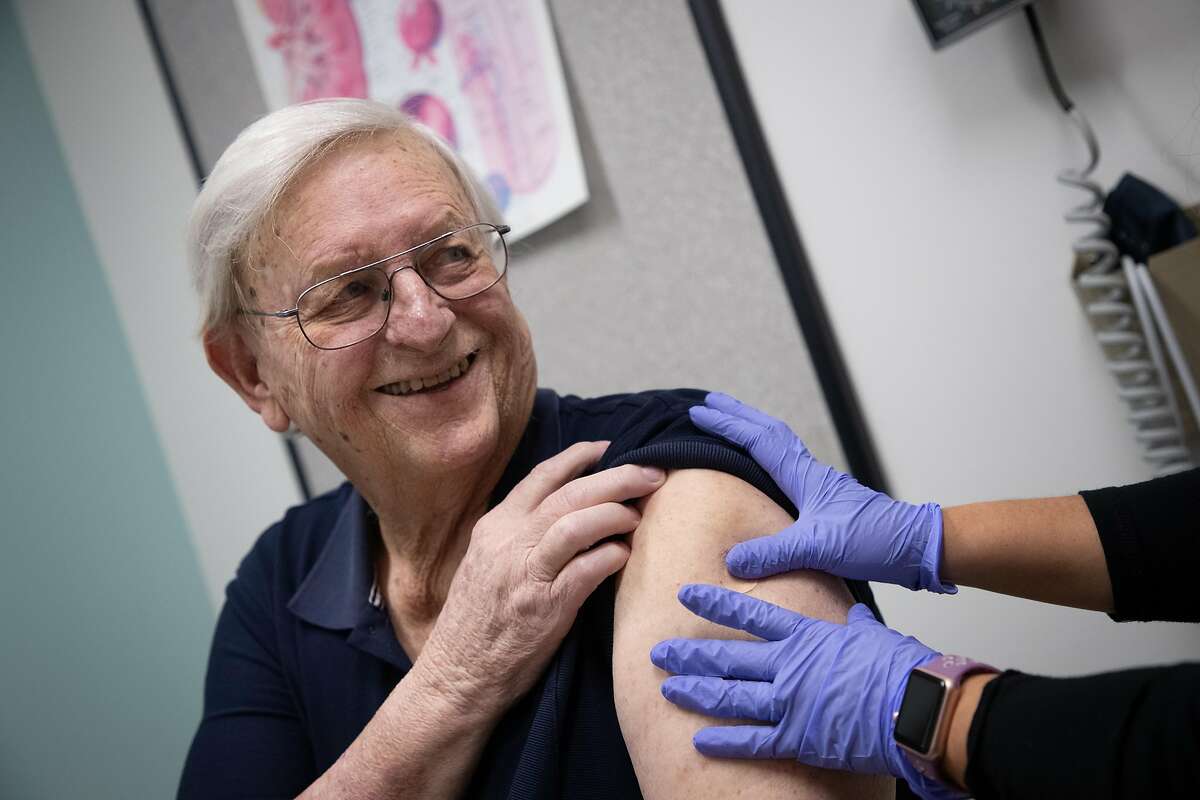 Ilda Villahermosa administers a flu shot to Terry Tifft, 70, of Woodside, at Kaiser Permanente Redwood City.