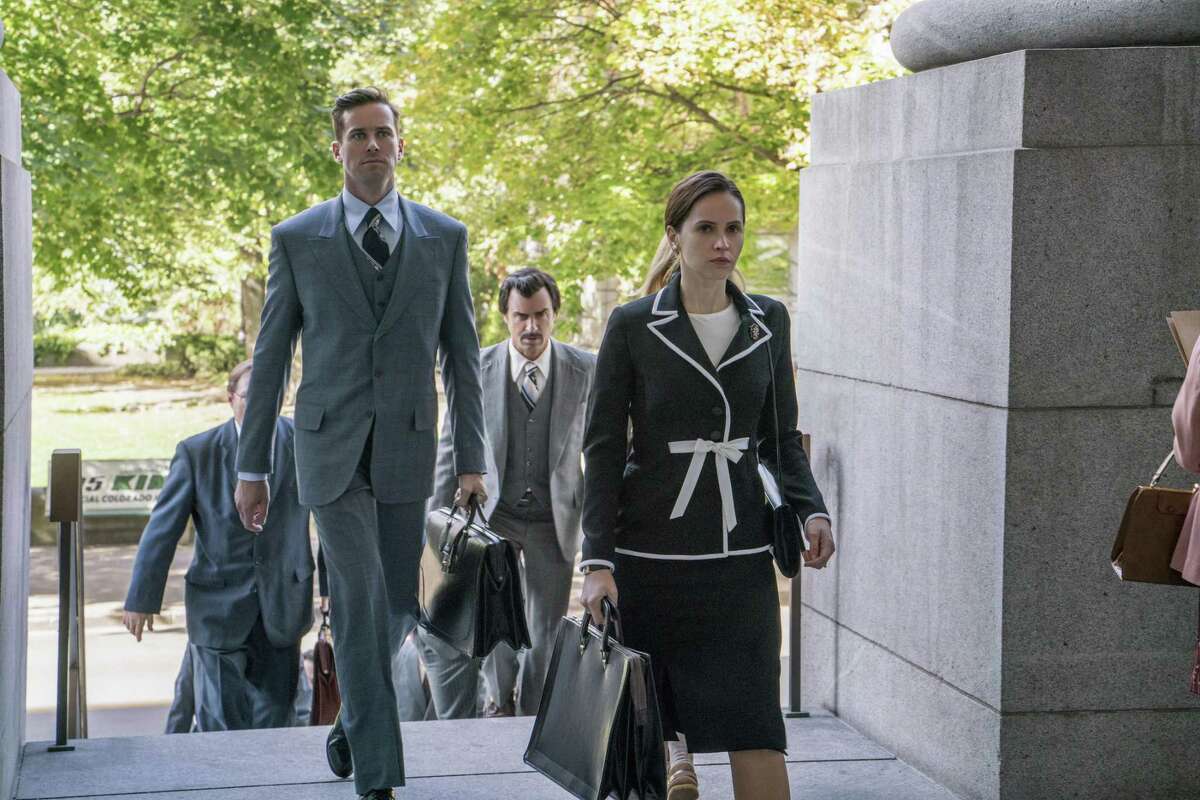 In this image released by Focus Features, Armie Hammer portrays Marty Ginsburg, from left, Justin Theroux portrays Melvin Wulf and Felicity Jones portrays Ruth Bader Ginsburg in a scene from “On the Basis of Sex.” (Jonathan Wenk/Focus Features via AP)