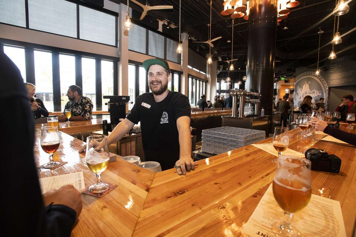 A bartender serves customers at Ballast Point Brewing Co. at Downtown Disney in Anaheim, CA. The restaurant and bar opened on Wednesday, January 16, 2019.