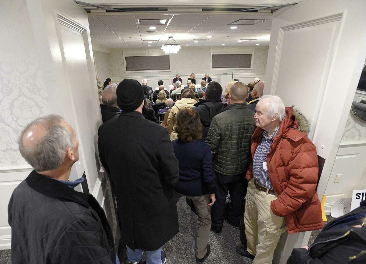 Attendee's listen from an open doorway as Connecticut State Senator Alex Bergstein (D-36) hosts a community meeting entitled "Bringing Business to CT" at the The Italian Center in Stamford, Connecticut on Wednesday, Jan. 23, 2019. A large contingent of residents and business owners opposed to Bergstein's proposal to add tolls to CT's highways, voiced their objections during the open public comment of the meeting.