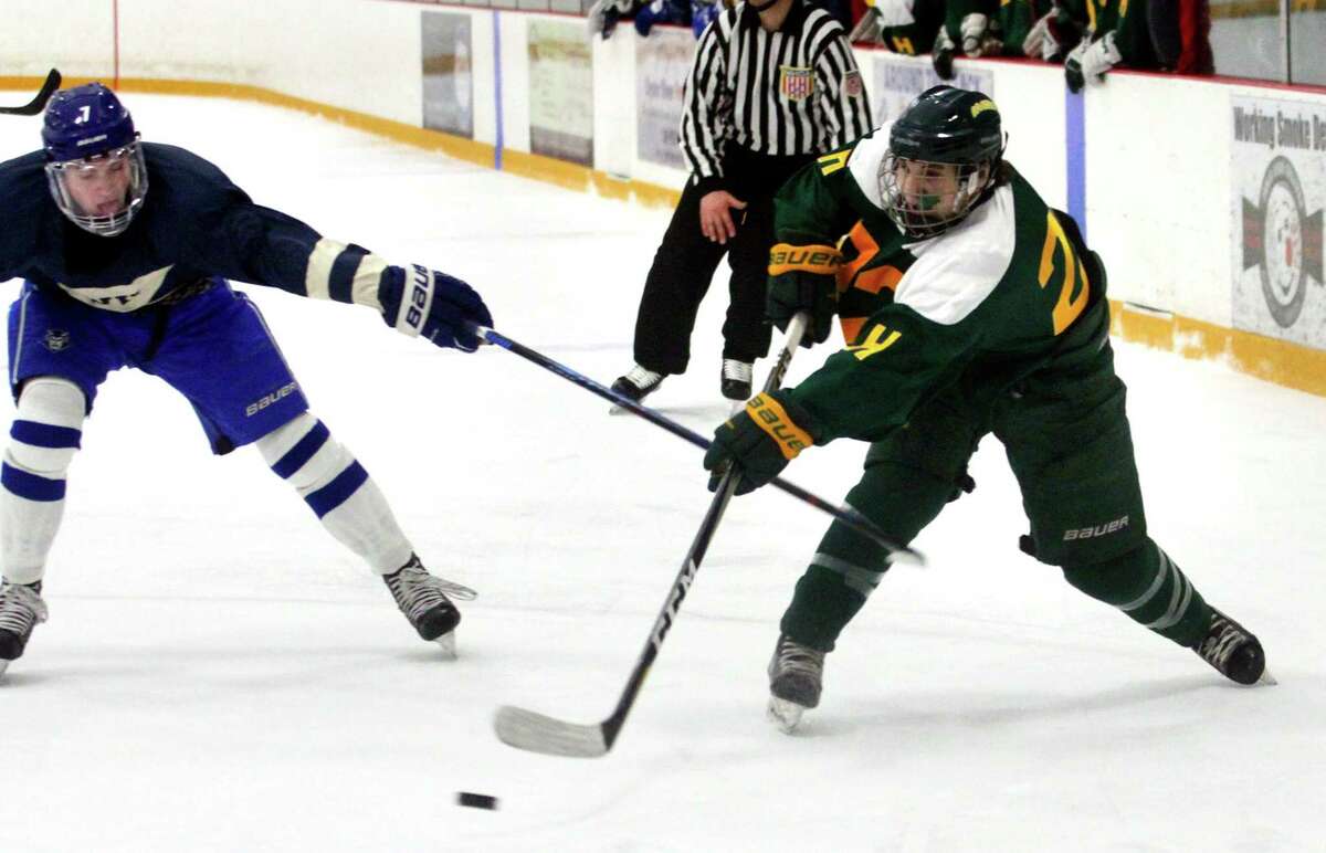 West Haven's Kaden Morgillo (7), left, tries to disrupt a pass by Hamden's Bryce Riccitelli (22) during hockey action in West Haven, Conn., on Wednesday Jan. 23, 2019.