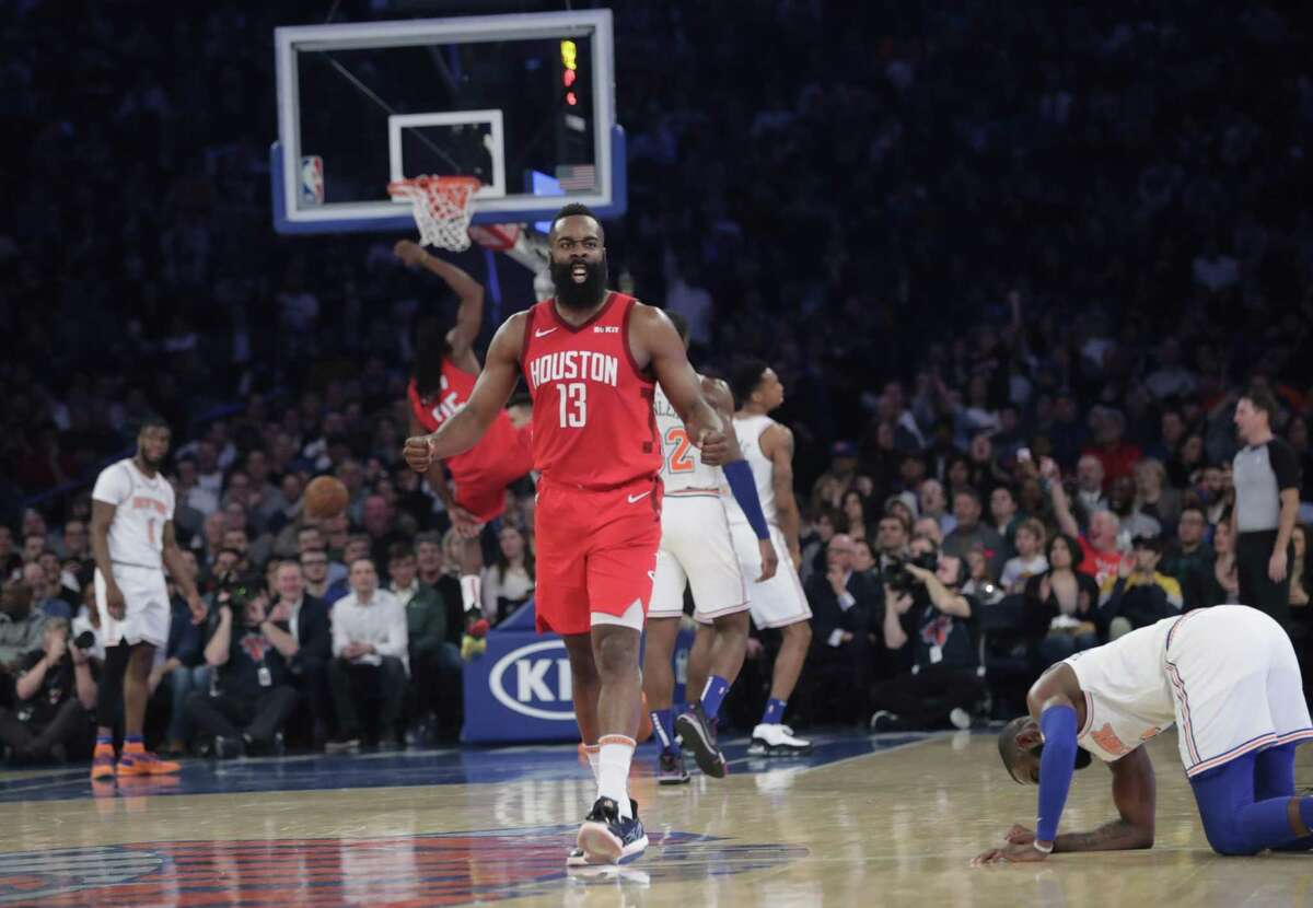 Houston Rockets' James Harden (13) reacts after teammate Kenneth Faried (35) dunked the ball during the second half of the team's NBA basketball game against the New York Knicks on Wednesday, Jan. 23, 2019, in New York. Harden scored 61 points as the Rockets won 114-110. (AP Photo/Frank Franklin II)