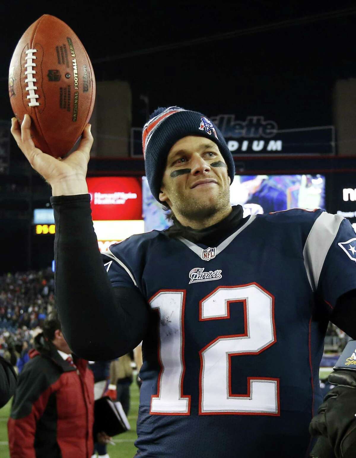 FILE - In this Jan. 10, 2015, file photo, New England Patriots quarterback Tom Brady holds up the game ball after an NFL divisional playoff football game against the Baltimore Ravens in Foxborough, Mass. A federal appeals court has ruled, Monday, April 25, 2016, that New England Patriots Tom Brady must serve a four-game "Deflategate" suspension imposed by the NFL, overturning a lower judge and siding with the league in a battle with the players union. (AP Photo/Elise Amendola, File)