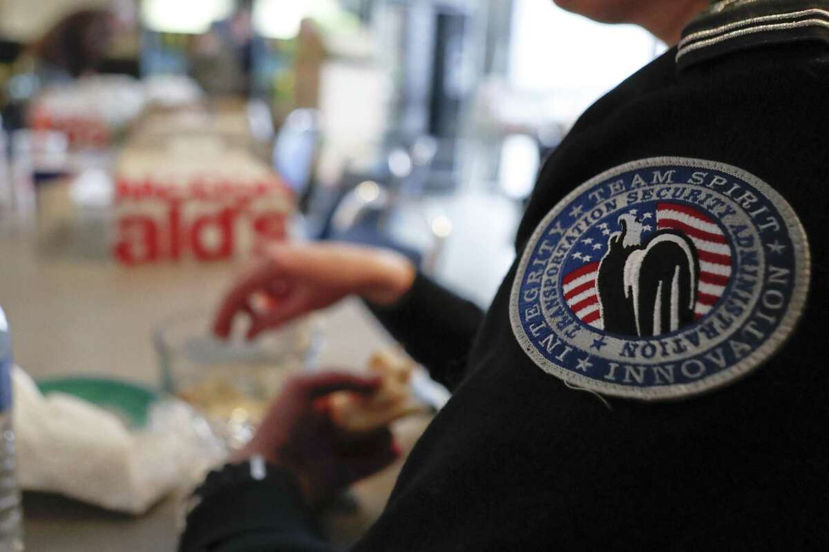 A TSA officer finishes her lunch as federal airport workers bring in donated boxes of meals from the McDonald's in the airport food court to the TSA break room, Friday, Jan. 18, 2019, at the Pittsburgh International Airport in Imperial, Pa. Because of the partial government shutdown, the restaurant has donated meals to the TSA workers. (AP Photo/Keith Srakocic)