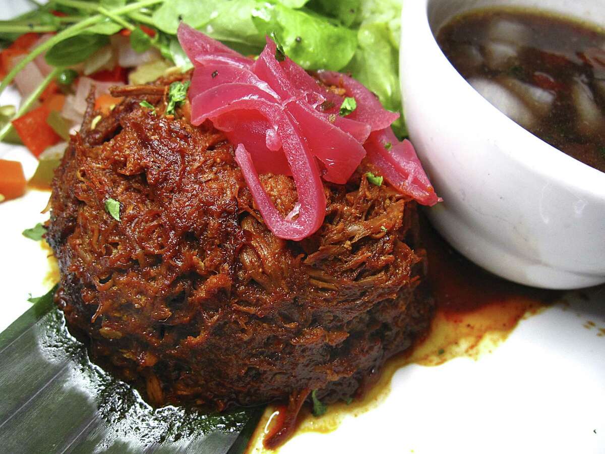 Cochinita pibil with black beans, cilantro rice and pickled onions from Ácenar Mexican restaurant on the River Walk.