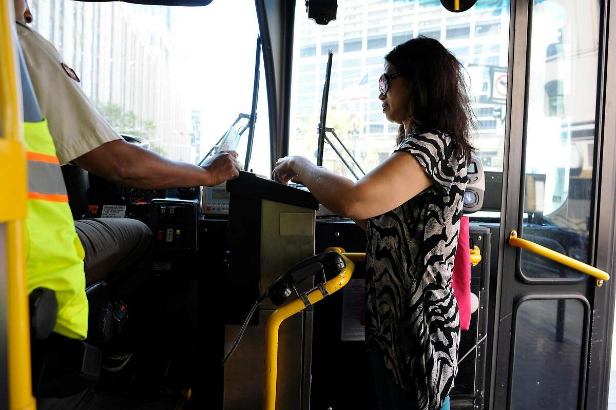 A woman pays her fare on a 9 San Bruno MUNI bus in San Francisco in 2015. A new study shows women are less likely to take mass transit due to safety concerns.