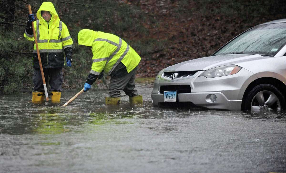 Norwalk DPW employees clear storm drains on Glover Ave. during the rainstorm Thursday, January 24, 2018, in Norwalk, Conn.