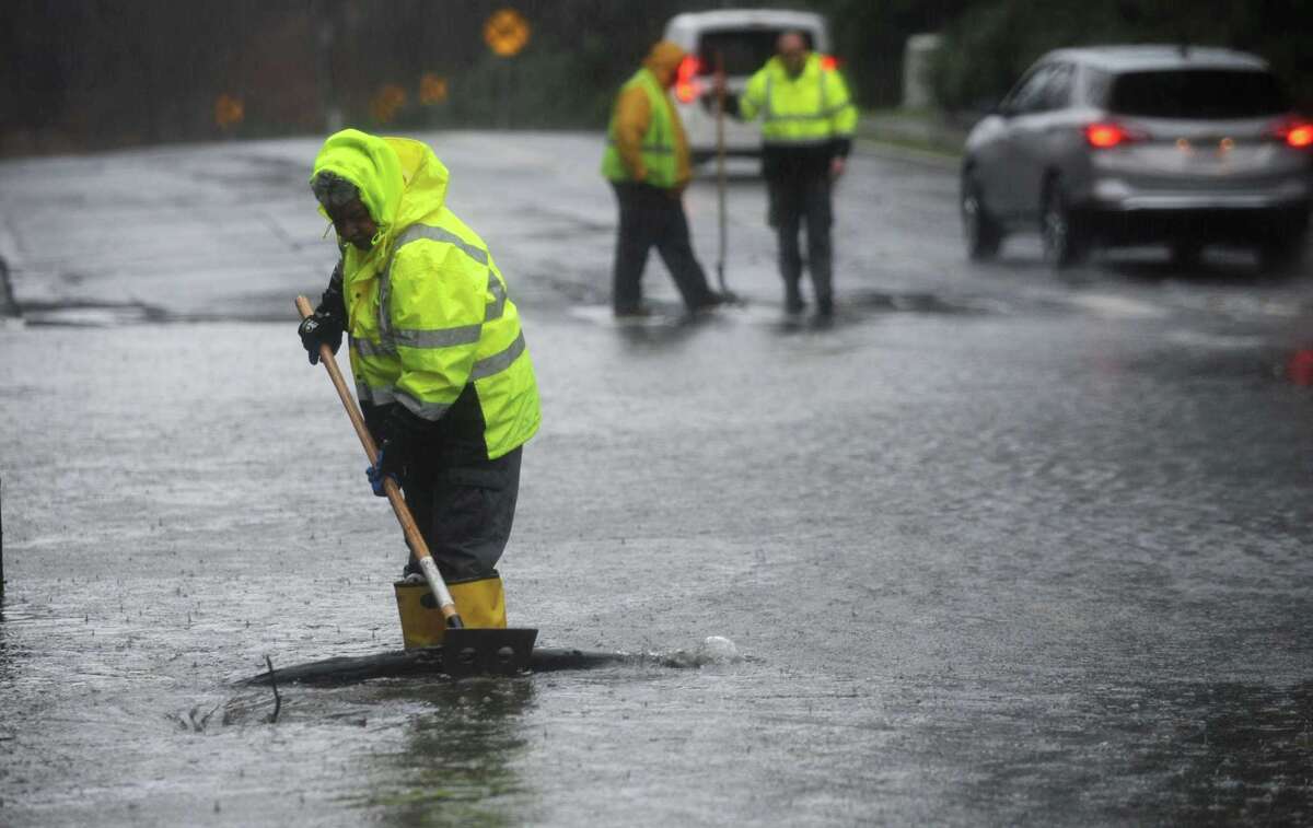 Norwalk DPW employees clear storm drains on Glover Ave. during the rainstorm Thursday, January 24, 2018, in Norwalk, Conn.