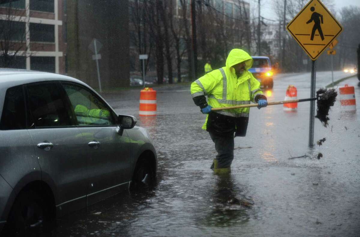 Norwalk DPW employees clear storm drains on Glover Ave. during the rainstorm Thursday, January 24, 2018, in Norwalk, Conn.