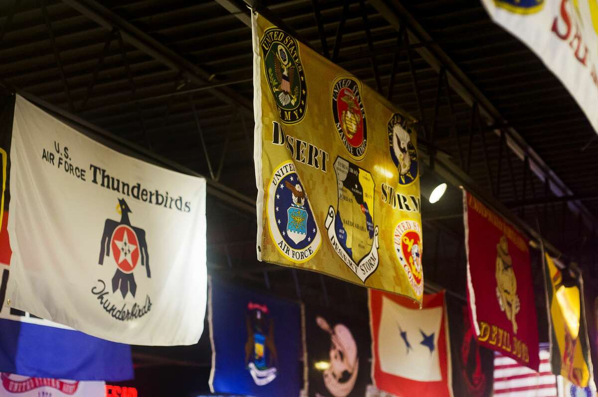 Various flags for veterans organizations and branches of the armed forces hang from the ceiling inside Boulevard Lounge at 316 S. Saginaw Road in Midland. (Katy Kildee/kkildee@mdn.net)