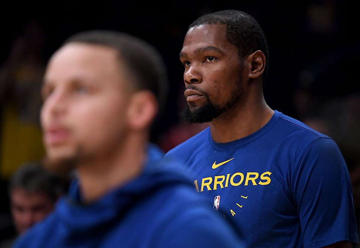 LOS ANGELES, CALIFORNIA - JANUARY 21: Kevin Durant #35 of the Golden State Warriors warms up behind Stephen Curry #30 before the game against the Los Angeles Lakers at Staples Center on January 21, 2019 in Los Angeles, California. NOTE TO USER: User expressly acknowledges and agrees that, by downloading and or using this photograph, User is consenting to the terms and conditions of the Getty Images License Agreement. (Photo by Harry How/Getty Images)