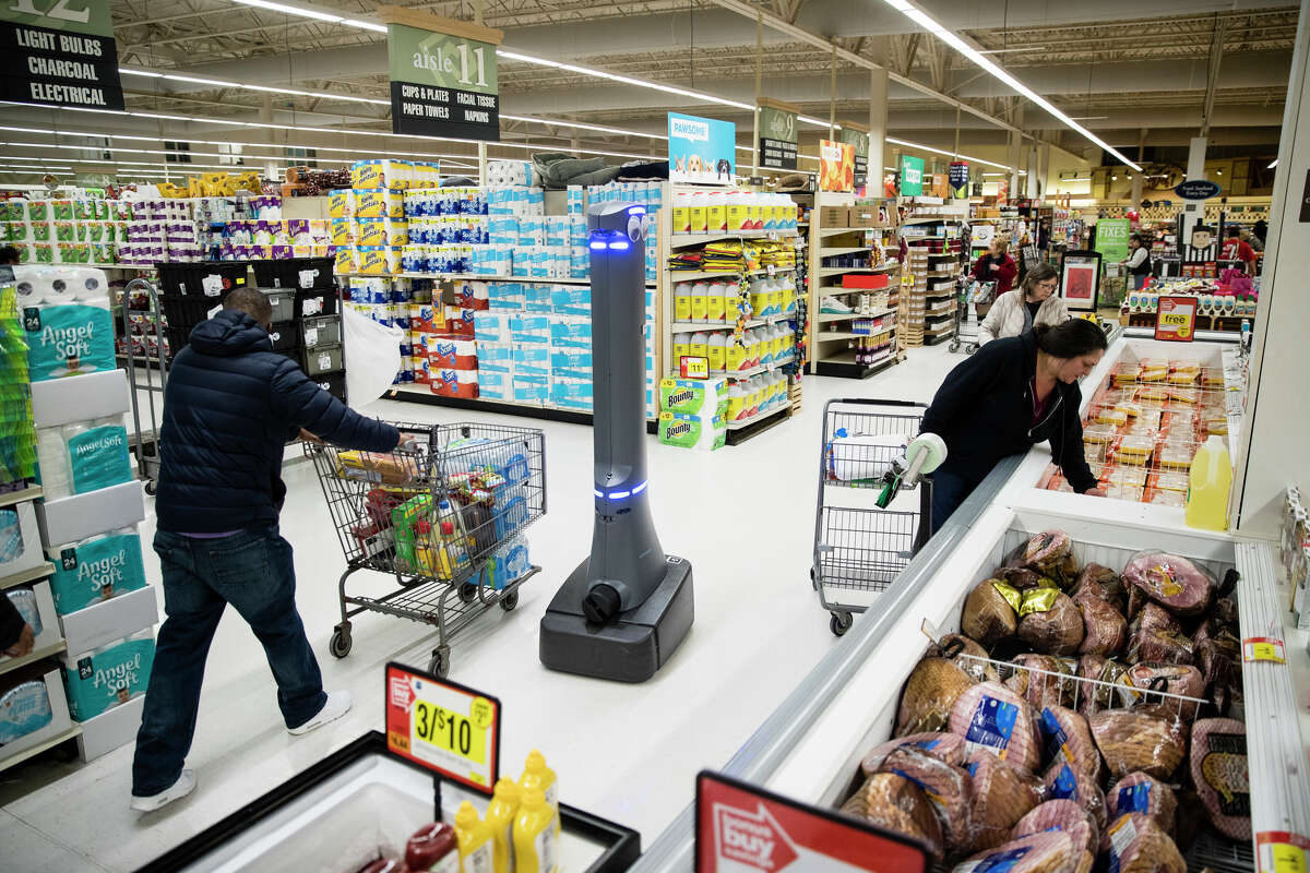 FILE- In this Jan. 15, 2019, file photo a robot named Marty cleans the floors at a Giant grocery store in Harrisburg, Pa. Robots aren?t replacing everyone, but a quarter of U.S. jobs will be severely disrupted as artificial intelligence accelerates the automation of today?s work, according to a new Brookings Institution report. The report published Thursday, Jan. 24, says roughly 36 million Americans hold jobs with ?high exposure? to automation, meaning about 70 percent of their work tasks could soon be performed by machines using current technology. (AP Photo/Matt Rourke, File)