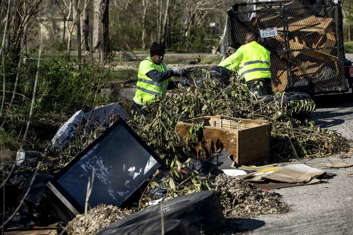 Lloyd Brewster and Anthony McDonald pick up illegally dumped garbage in the Settegast neighborhood on Thursday, Jan. 24, 2019, in Houston. Settegast is among the neighborhoods just north of I-610 where development is beginning to proceed at breakneck pace as region’s population, incomes and demand for housing increase.