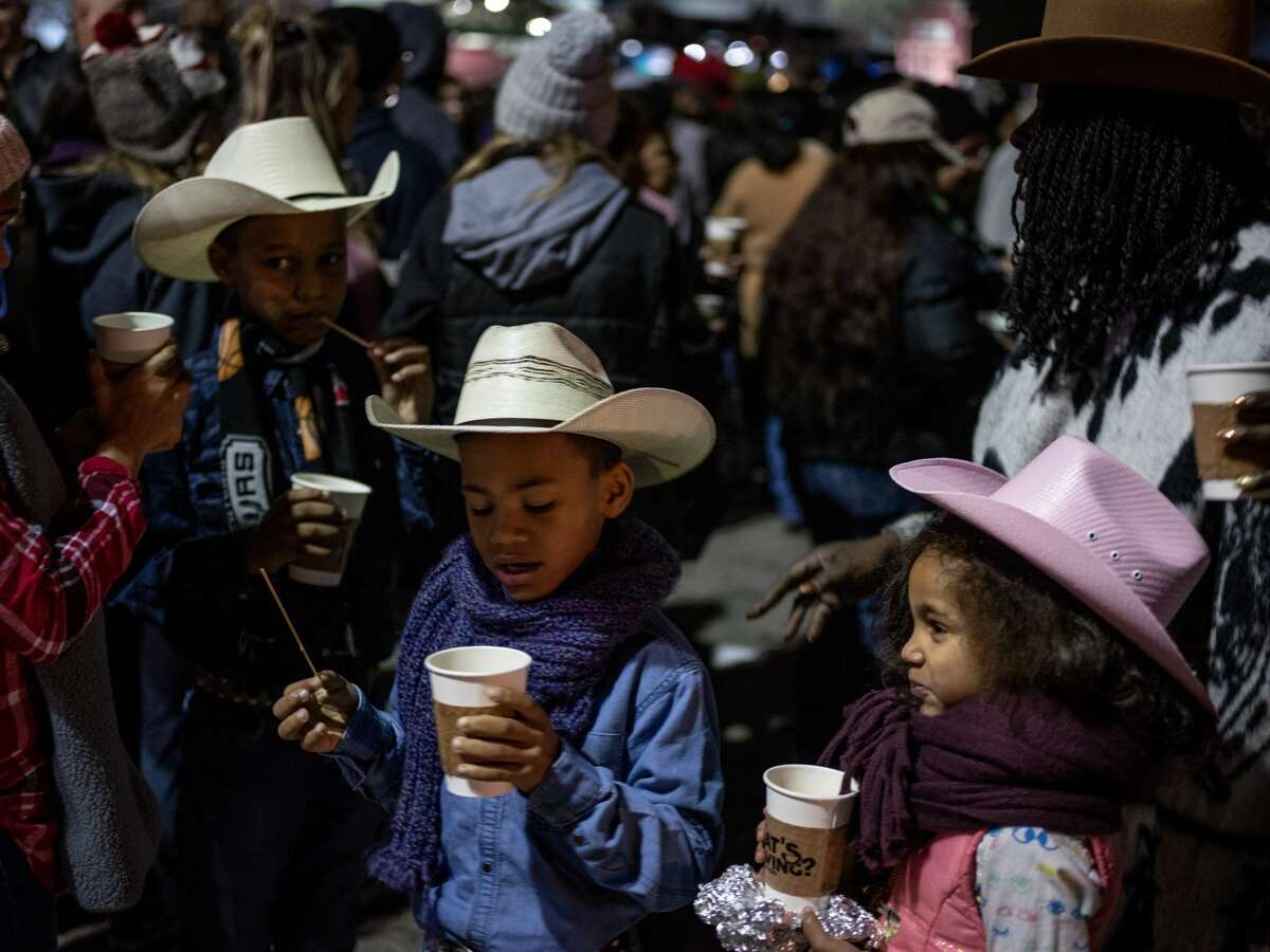 From left, siblings Miracle Irvin, 11, John Irvin, 9, Christian Irvin, 8, and Kimberley Irvin, 6, hold onto their warm cups of coffee along with their mother Johnny Ivin-Wilcher, right, during the 41st annual San Antonio Cowboy Breakfast held outside Cowboys Dancehall in San Antonio, Texas on Friday, January 25, 2019. The Cowboy Breakfast started in 1979 and has continued until this year where it draws over 30,000 people for free tacos, coffee and other food to kick off the San Antonio Stock Show and Rodeo.