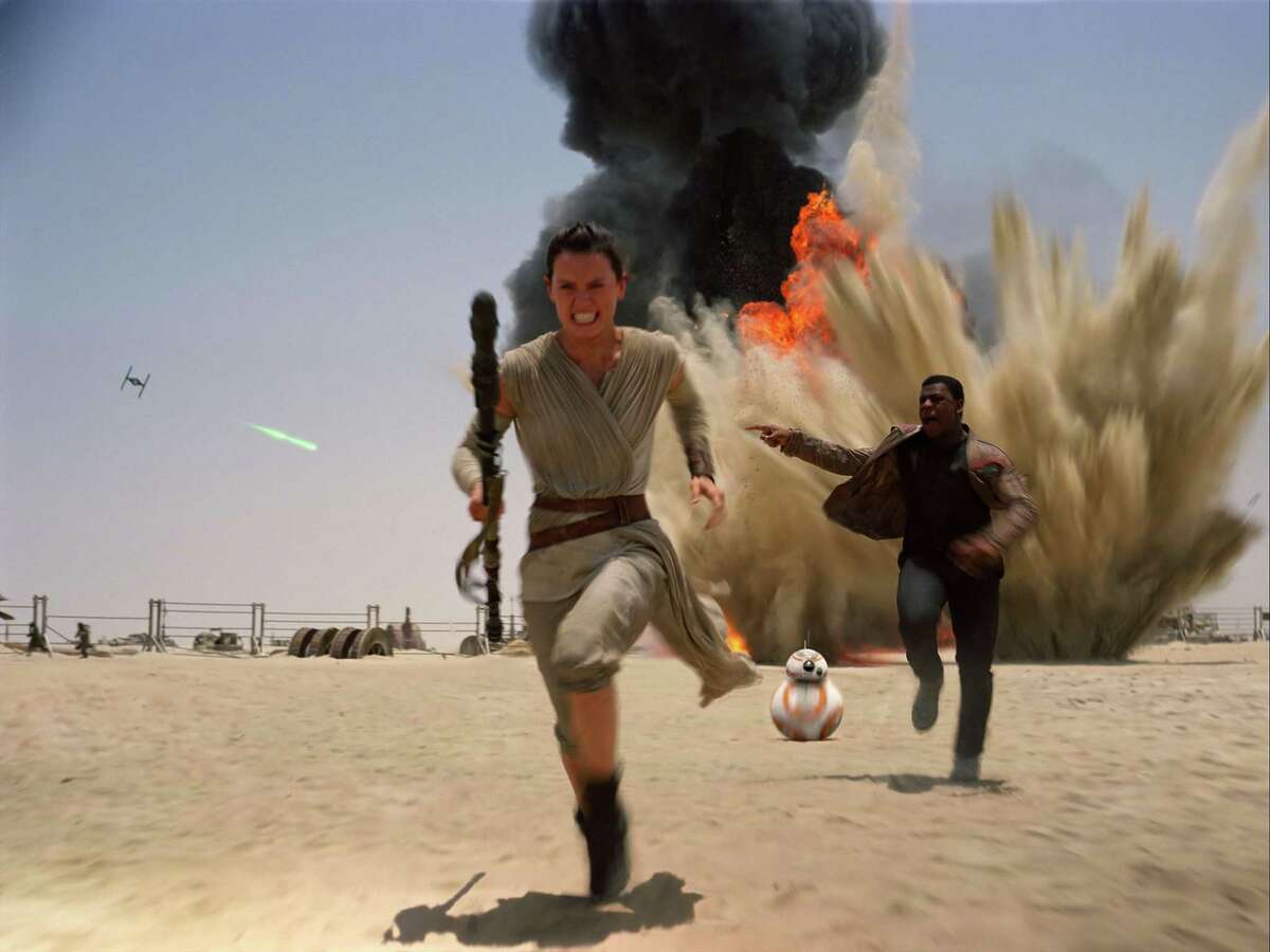 This photo provided by Disney shows Daisy Ridley as Rey, left, and John Boyega as Finn, in a scene from the new film, "Star Wars: The Force Awakens." Disney, which owns the Star Wars franchise, is expected to make the popular TV shows and movies a centerpiece of its upcoming streaming service, Disney+.