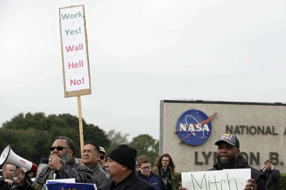 People protest outside of NASA's Johnson Space Center against the government shutdown Tuesday, Jan. 15, 2019, in Houston.