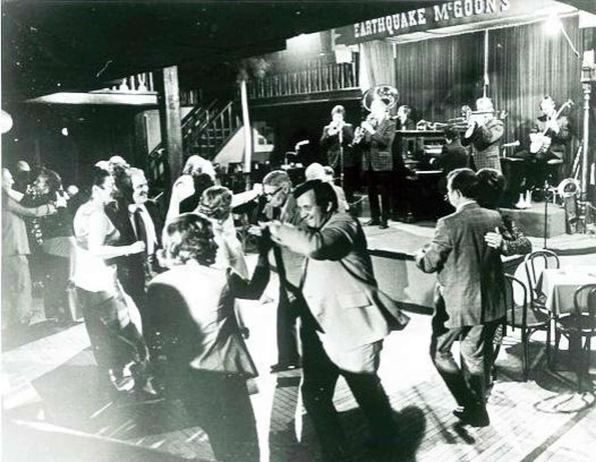 The dance floor is full of patrons dancing to the sounds of the Turk Murphy Jazz Band, playing at Earthquake McGoon's at 630 Clay Street in San Francisco, circa 1973.