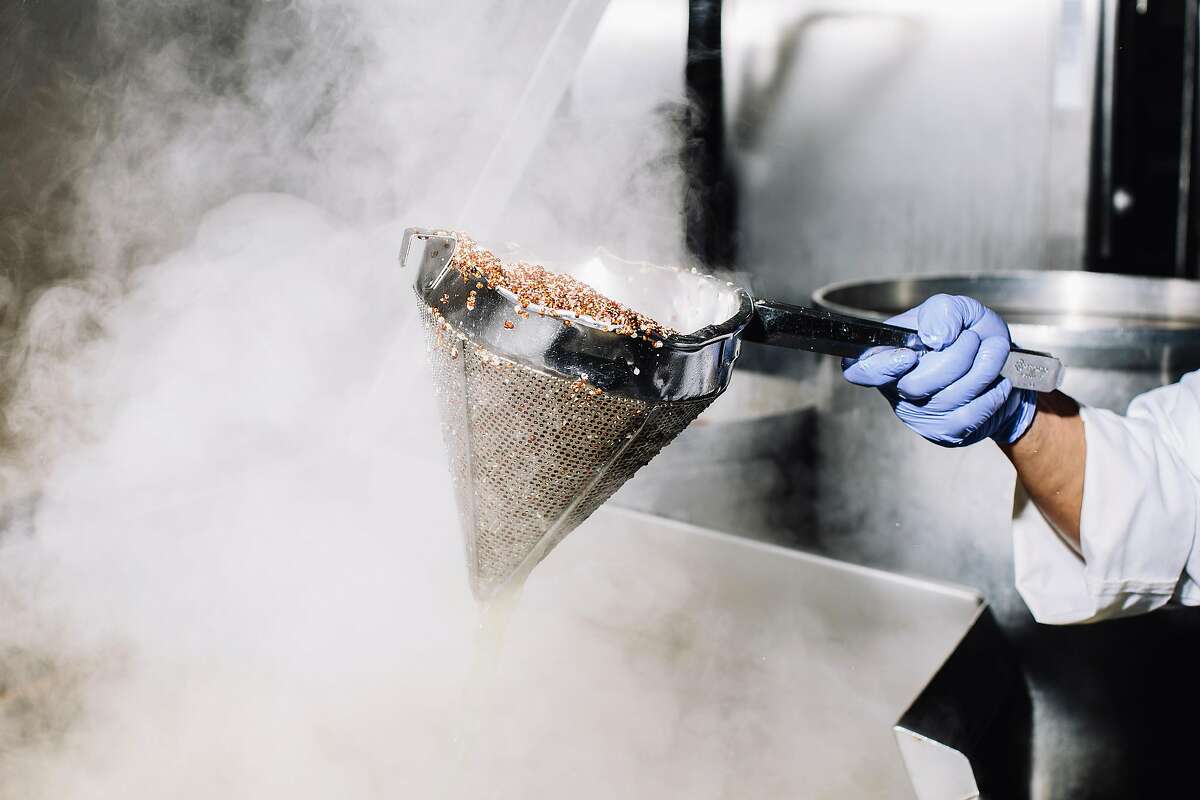 A worker removes cooked quinoa from a tilt skillet at Munchery's kitchen in San Francisco, Calif. on Tuesday, April 19, 2016.