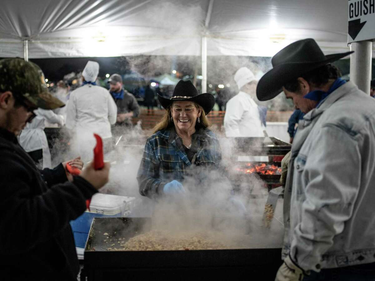 From left, volunteers Blake Evans, Sarah Mosher, and Jack Evans, cook up bacon and eggs during the 41st annual San Antonio Cowboy Breakfast held outside Cowboys Dancehall in San Antonio, Texas on Friday, January 25, 2019. The Cowboy Breakfast started in 1979 and draws over 30,000 people for free tacos, coffee and other food to kick off the San Antonio Stock Show and Rodeo. This is Mosher and Jack Evan's 25th year and Blake's 1st volunteering to cook for the breakfast. "We had to bring him in right," Mosher said.