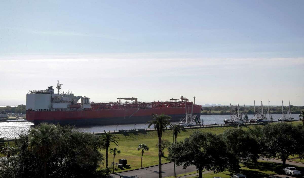 A large vessel passes by downtown Port Arthur.