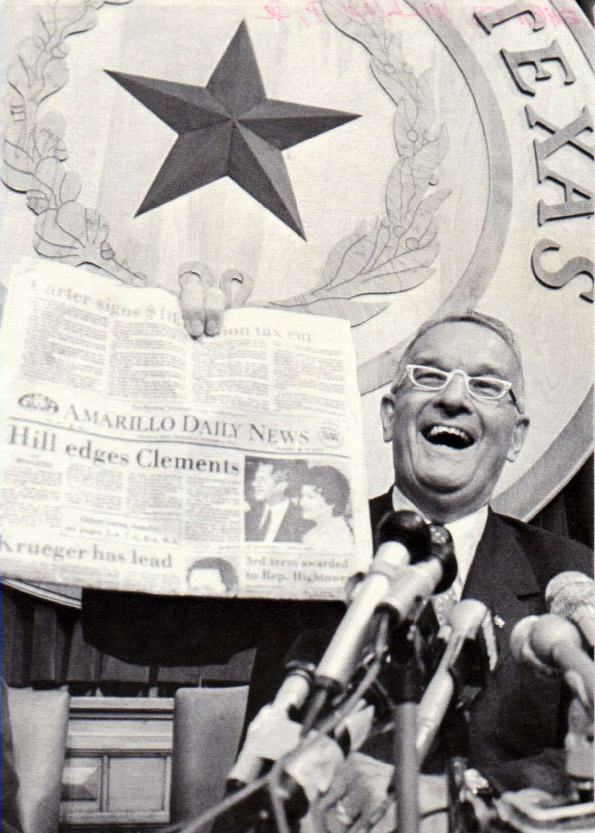 Successful Republican candidate for Governor Bill Clements holds up a newspaper [ The Amarillo Daily News ] bearing a headline reminiscent of the Truman-Dewey headline in 1948. The newspaper proclaims "Hill edges Clements." UPI photo