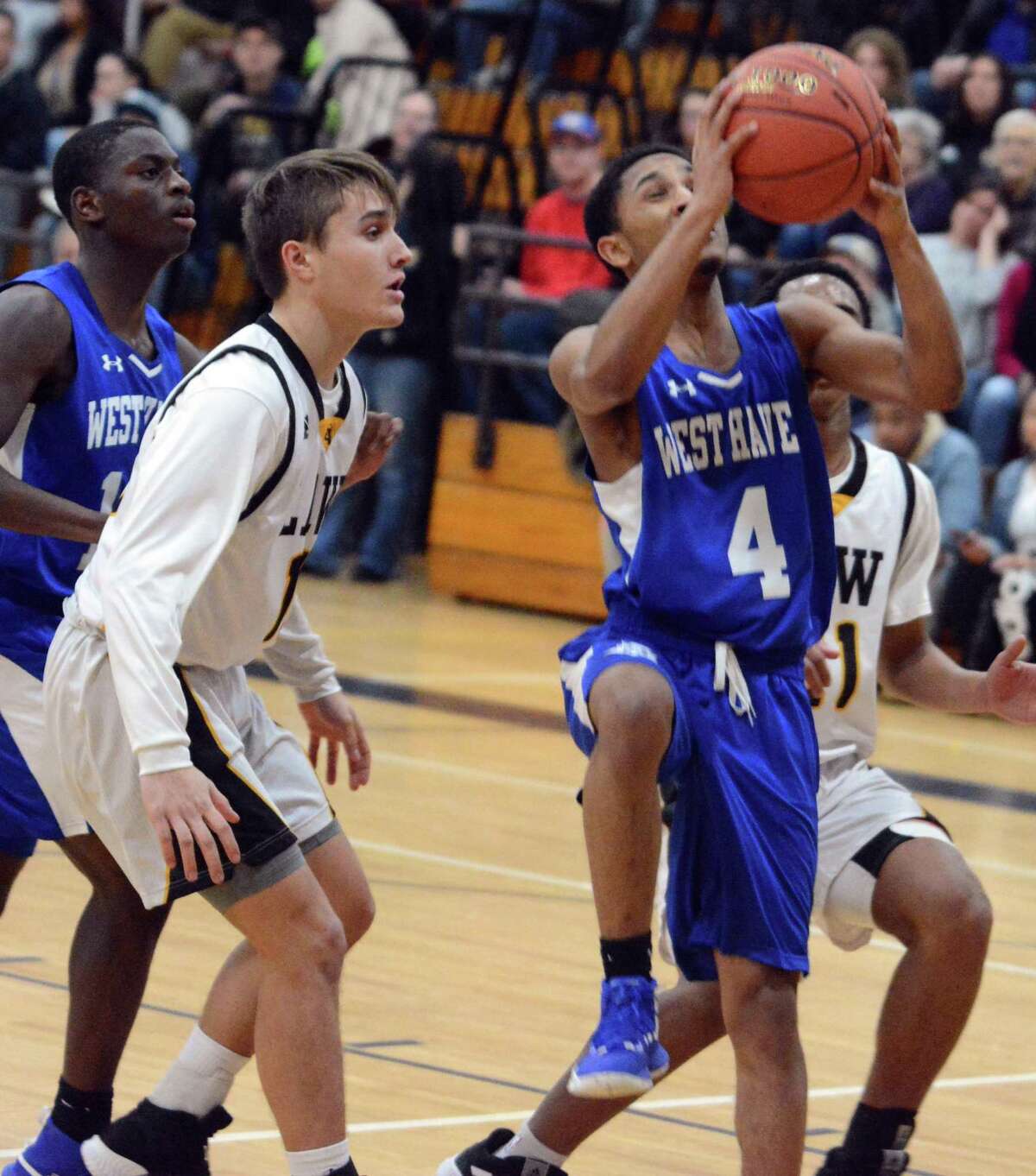 West Haven’s Tyrese Hargrove drives to the basket in front of Law’s Jon Vitale on Friday.