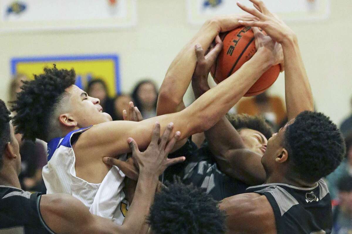 Clemens big man Kavon Booker battles for a rebound in a crowd as Clemens hosts Steele in boys basketball on January 25, 2019.