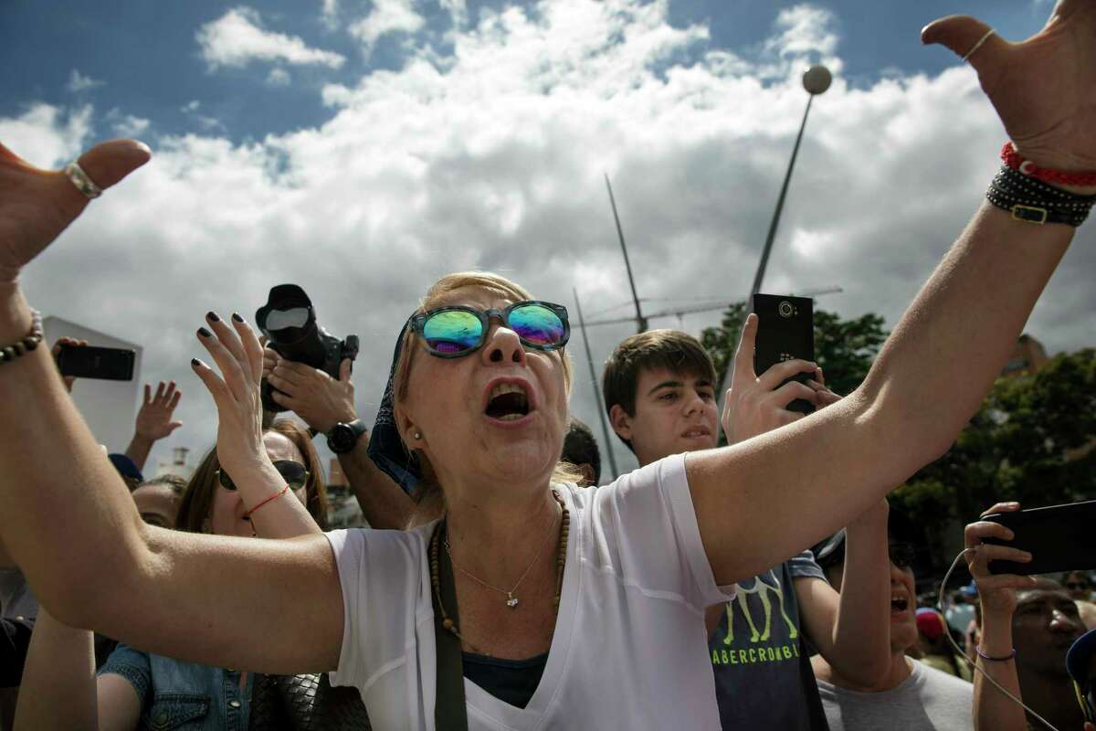 A woman cheers on Venezuela's self-declared interim leader Juan Guaido at the end of a rally in a public plaza in Las Mercedes neighborhood of Caracas, Venezuela, Saturday, Jan. 29, 2019. Venezuela's political showdown moves to the United Nations where a Security Council meeting called by the United States will pit backers of President Nicolas Maduro against the Trump administration and supporters of Guaido.