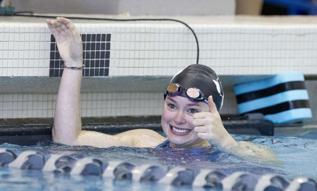 Cori Eckert of Willis gives a thumbs-up to the crowd after finishing first in her heat of the girls 50-yard freestyle during the District 21-5A Swimming & Diving Championships at the Tomball ISD Aquatic Center, Saturday, Jan. 26, 2019, in Tomball.