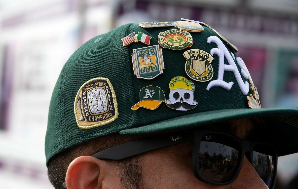 A devoted fan sports a hat covered with pins at Oakland Athletics FanFest 2019, at Jack London Square in Oakland, Calif., Saturday, Jan. 26, 2019. A's supporters arrived by the thousands to see their favorite players, coaches and former stars as the club prepares for the new baseball season.