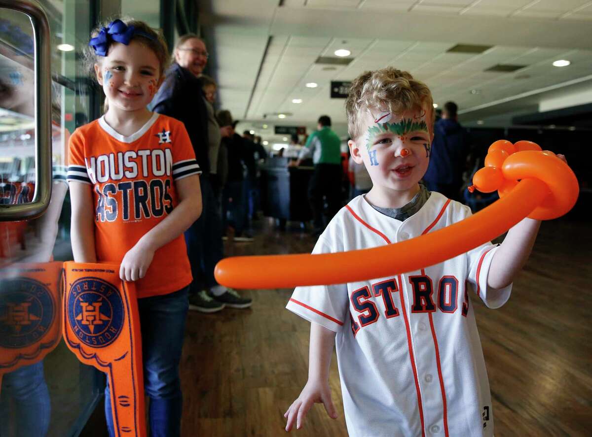 Sister and brother Genevieve Wingard, 6, and Jackson Wingard, 4, have fun at the Astros Fan Fest with their father, Daniel Wingard, and uncle, Michael Wingard, on Saturday, Jan. 26, 2019, in Houston.
